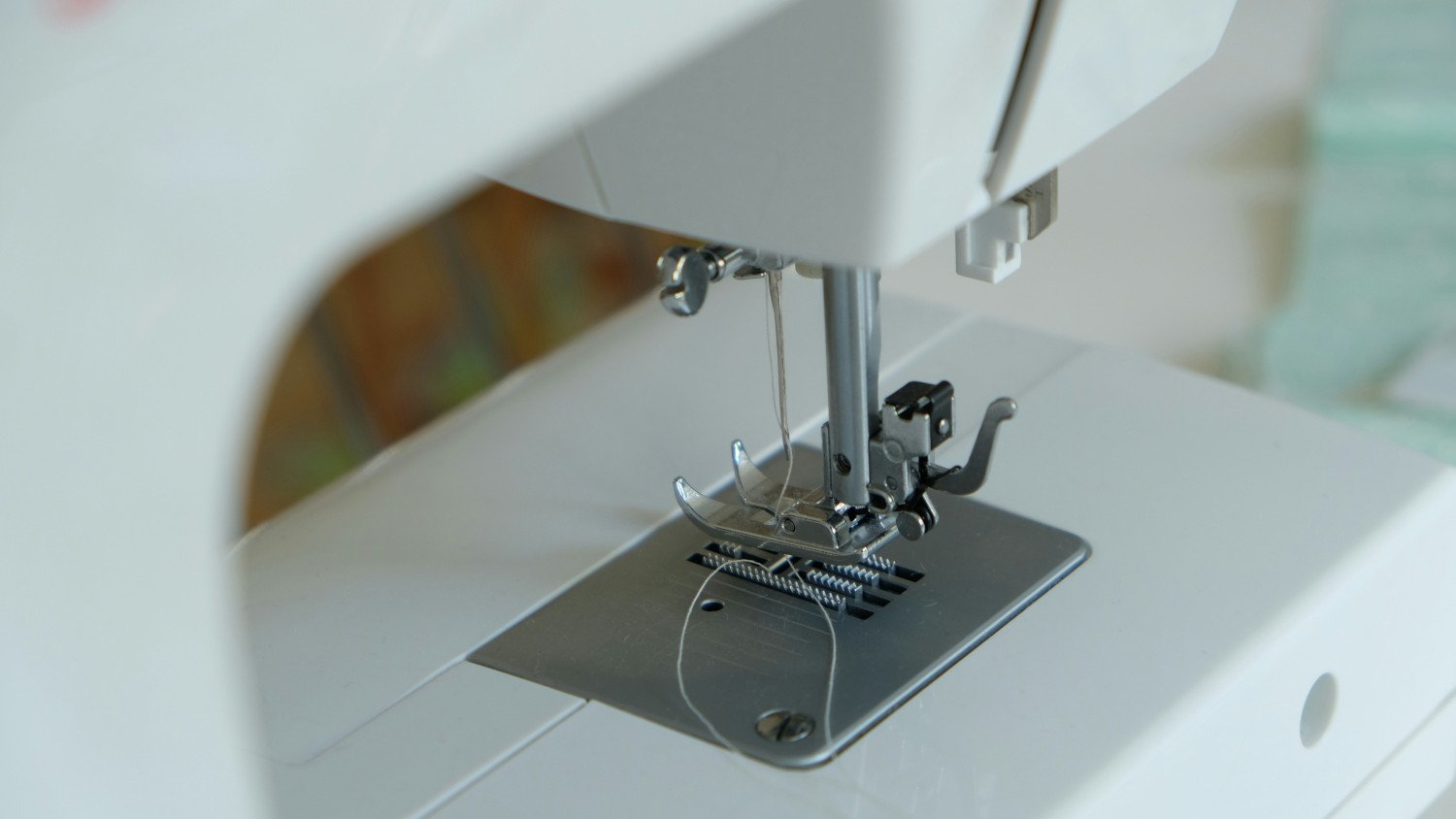 Overcome your fears and start sewing! Image of a sewing machine footer plate and threaded needle.